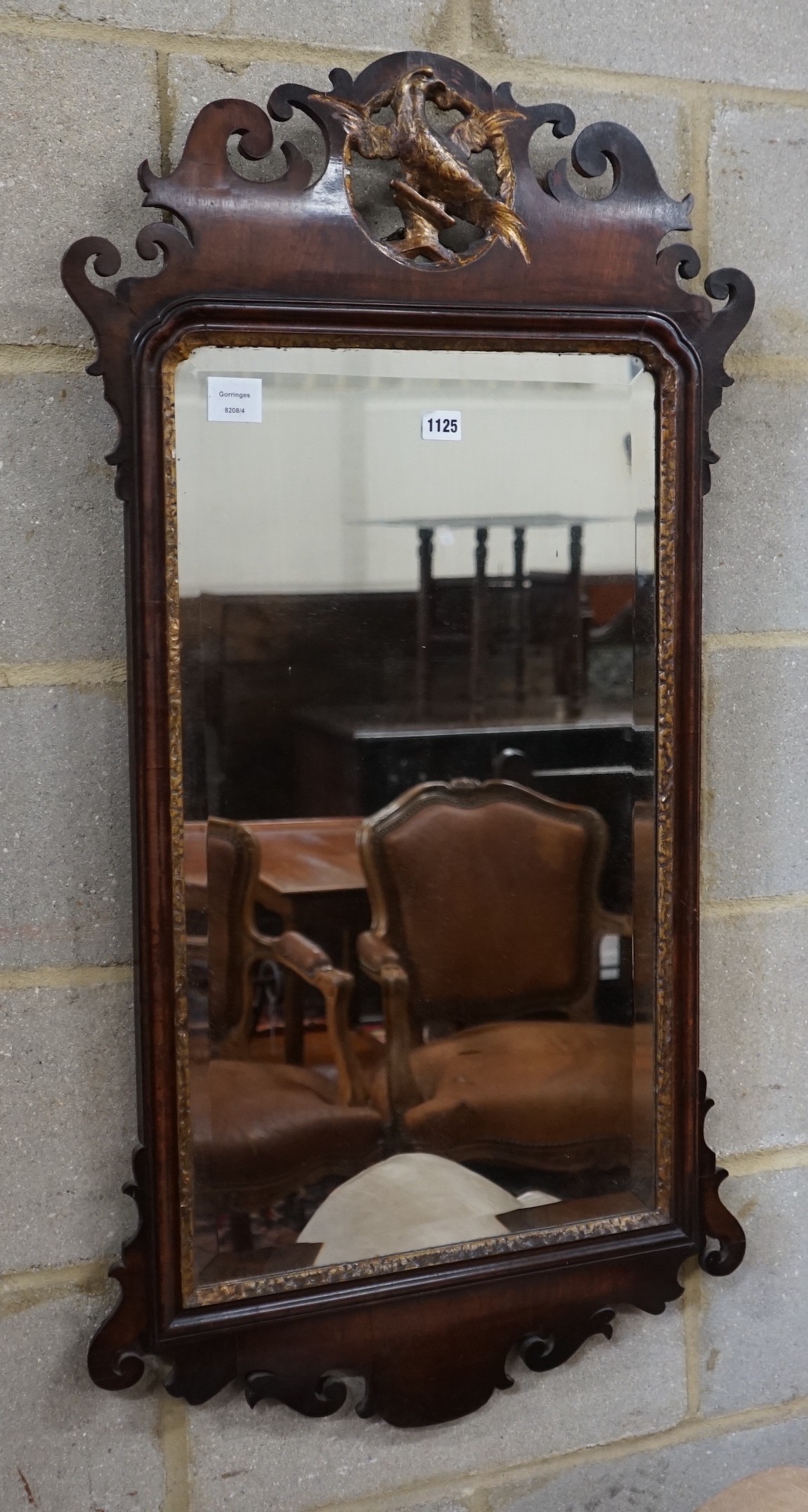 A George III style mahogany fret cut wall mirror, with gilt carved eagle surmount, width 56cm, height 108cm